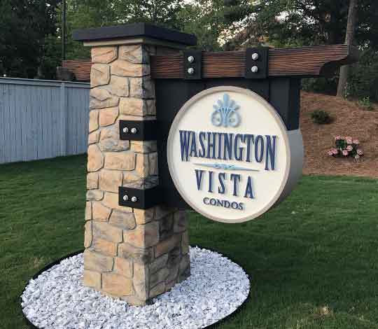 Stone Sign Column with Wood Arm Suspending Sign in Historical Disrtict Installed and Landscaped