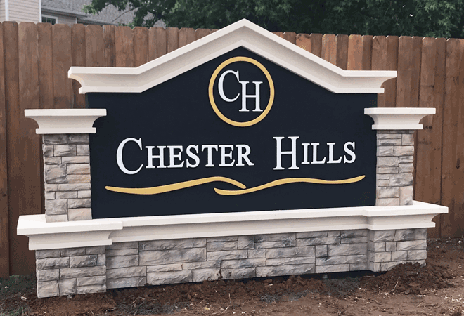 Residential Development Entrance Sign Monument with Faux Stacked Stone Base and Columns - Chester Hills